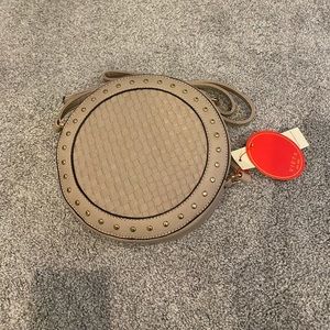 New w tags, round crossbody purse w cute studs.